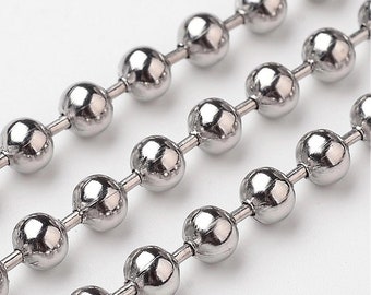 May include: A close-up of a silver ball chain necklace. The chain is made of small, round metal beads connected by thin metal links.