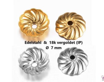 May include: Four metal bead caps, two gold and two silver, with a swirl design. Each cap has a 7 mm diameter hole in the center.