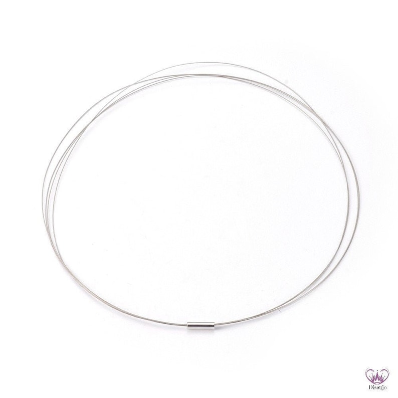 May include: A silver necklace with a thin, delicate chain. The chain is made of multiple strands of wire that are twisted together. The necklace has a simple, minimalist design.