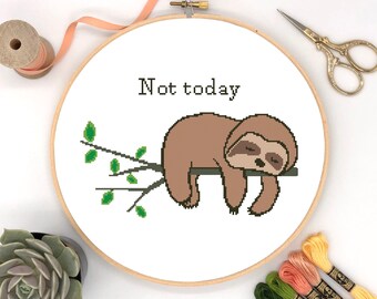 May include: A white embroidery hoop with a cross-stitch design of a sloth sleeping on a branch. The text "Not today" is above the sloth.