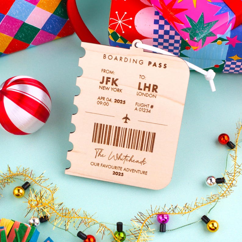 May include: Wooden boarding pass with the text "BOARDING PASS" and details for a flight from JFK New York to LHR London on April 4, 2025. The pass includes the text "The Whiteheads, OUR FAVOURITE ADVENTURE 2025".