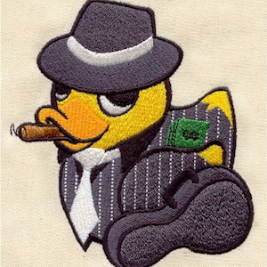 May include: An embroidered patch featuring a yellow duck dressed as a mobster. The duck wears a dark grey pinstripe suit, a white tie, and a matching fedora. It holds a brown cigar in its beak and carries a dark grey violin case with a green stack of cash.
