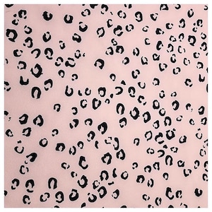 Könnte beinhalten: Ein rosa Stoff mit einem schwarzen Leopardenmuster.
