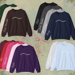 May include: A collection of crewneck sweatshirts in various colors including forest green, sand, dark chocolate, black, dark heather, sport grey, navy, maroon, red, heliconia, light pink, purple, ash grey, and light blue, each with the text I'd rather be reading.