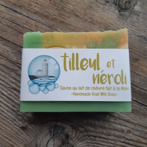 May include: A bar of green, yellow and orange soap with a white label that reads "Tilleul et nerdi" and "Savon au lait de chèvre fait à la Main -Handmade Goat Milk Soap-".