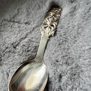 May include: A set of three ceramic canisters with lids, featuring a geometric pattern in shades of blue, white, and gray. The canisters vary in size, suitable for kitchen storage.