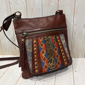 May include: A set of three ceramic mugs with a speckled, matte finish. The mugs are in shades of cream, light gray, and dark gray. Each mug has a simple, minimalist design and a rounded handle. Perfect for coffee or tea.