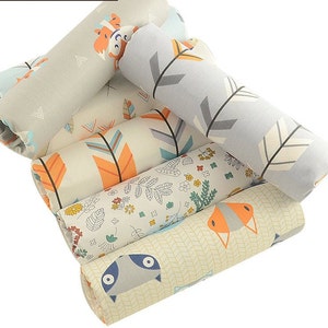 May include: A set of six fabric scraps featuring different patterns, including arrows, flowers, and animals. The fabrics are in shades of gray, blue, orange, and white.
