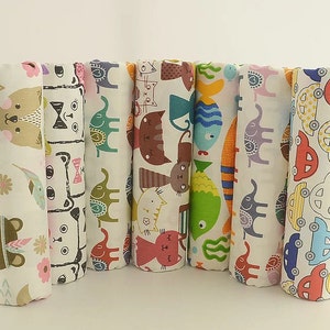 May include: Set of eight fabric panels with different colorful animal and vehicle prints. The panels are white with various colored designs, including cats, fish, elephants, and cars.