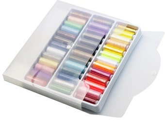 May include: A white plastic storage box with a clear lid, filled with colorful spools of thread. The box has a button closure and is designed to hold and organize sewing thread.