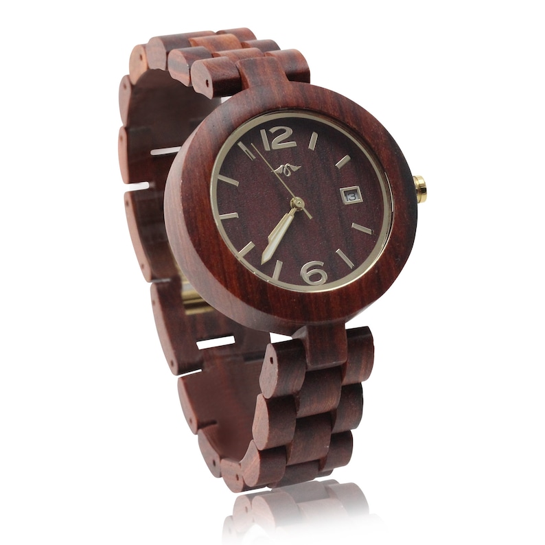 May include: A dark red wooden wristwatch with a round face and gold-colored hands and hour markers. The watch has a wooden band.