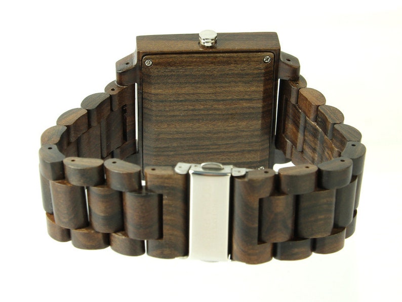 May include: A dark brown wooden wristwatch with a square face and a metal clasp. The watch band is made of linked wooden pieces.