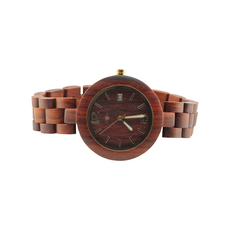 May include: A wooden wristwatch with a brown wooden band and a round, dark red face. The watch face has gold-colored hands and hour markers.