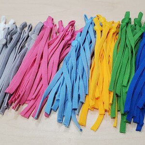 May include: Assortment of colorful elastic cords with adjustable toggles, perfect for making face masks or other crafts.