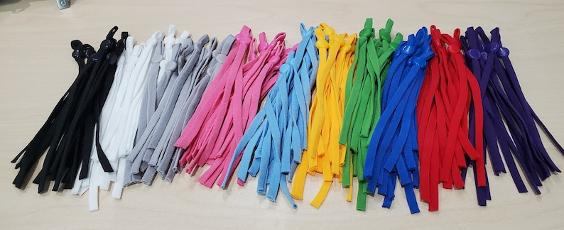 May include: Assortment of colorful elastic cords with adjustable toggles, perfect for making face masks or other crafts.