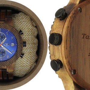 May include: A wooden wristwatch with a blue face and chronograph features. The back of the watch is engraved with the text "Tania and Jerry Forever 2015.08.19".