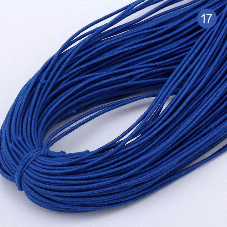 May include: A close-up of a bundle of royal blue elastic cord. The cord is tightly wound and appears to be made of a soft, stretchy material.