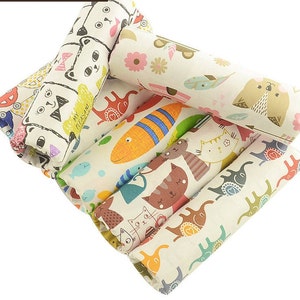 May include: A set of six fabric scraps featuring various colorful animal and fish designs. The designs include cats, elephants, fish, and birds. The fabric is a light beige color with a subtle texture.
