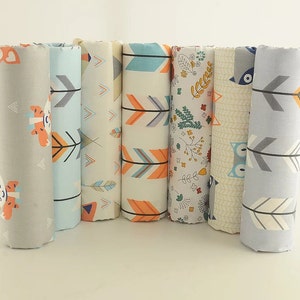 May include: Six fabric swatches with different patterns, including arrows, owls, and floral designs. The swatches are in shades of gray, blue, orange, and white.