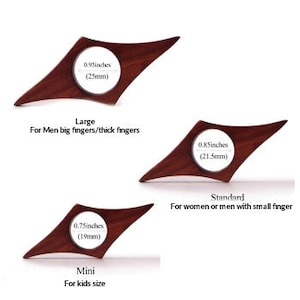 May include: Three wooden guitar picks in different sizes: large, standard, and mini. The picks are shaped like a diamond with rounded edges. The sizes are labeled with measurements in inches and millimeters. The large pick is for big fingers, the standard pick is for small fingers, and the mini pick is for kids.