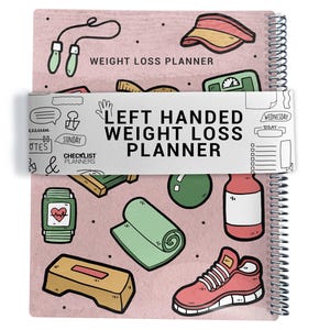 May include: A spiral-bound weight loss planner with a pink cover featuring fitness-related illustrations. The planner includes the text "WEIGHT LOSS PLANNER" and "LEFT HANDED WEIGHT LOSS PLANNER". Illustrations include a jump rope, weights, a yoga mat, and a running shoe.