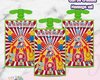 May include: Three flexible pouches with green plastic spouts featuring a circus theme. The design includes a red and white striped tent, a clown, an elephant, a lion, and balloons. Text reads: "CAVIRIA IS 2" and "Matching Favors can be created Message us!"