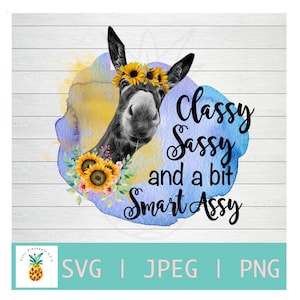 May include: A black and white illustration of a donkey wearing a sunflower crown and floral accents. The text reads "Classy, Sassy, and a bit Smart Assy" in black script. The background features watercolor-style splashes of yellow and blue.
