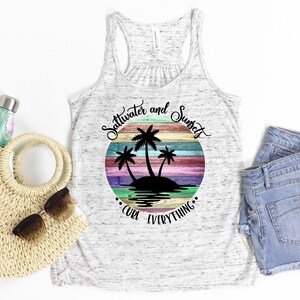 May include: White tank top with a colorful sunset graphic and the text "Saltwater and Sunsets Cure Everything".