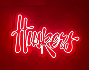 May include: A white neon sign with the word "Thinkers" in a stylized font against a red background.