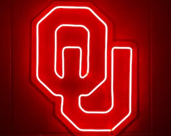 May include: A red neon sign in the shape of the letters "OU" for the University of Oklahoma.