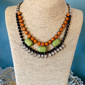Gorgeous CUE Peter Lang necklace with shiny crystals on gunmetal chain necklace 15” + 2 1/2 extender, Orange, green, clear abs black stones