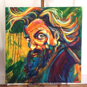 May include: A colorful painting of a man with a long beard and wild hair. The painting is done in a vibrant style with bright colors and bold strokes. The man's face is expressive and his eyes are piercing.
