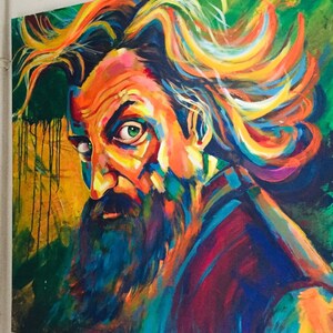 May include: A colorful abstract painting of a man with long, flowing hair and a beard. The painting is done in a variety of bright colors, including red, orange, yellow, green, blue, and purple. The man's face is partially obscured by his hair, but his piercing green eye is visible. The background of the painting is a dark green.