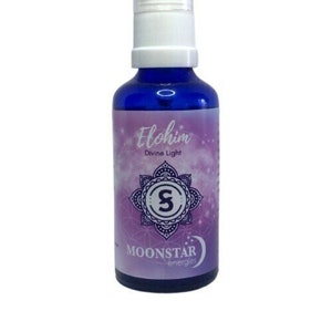 May include: A blue glass bottle with a white spray nozzle and a purple label. The label says "Elohim Divine Light" and features a purple mandala with a white "S" in the center. The label also says "Moonstar energies".