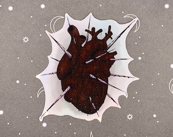 May include: A brown anatomical heart with a white background. The heart is pierced with multiple sharp, white spikes. The background is a white, iridescent, splatter pattern.