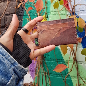 Brown leaf wallet hand holding