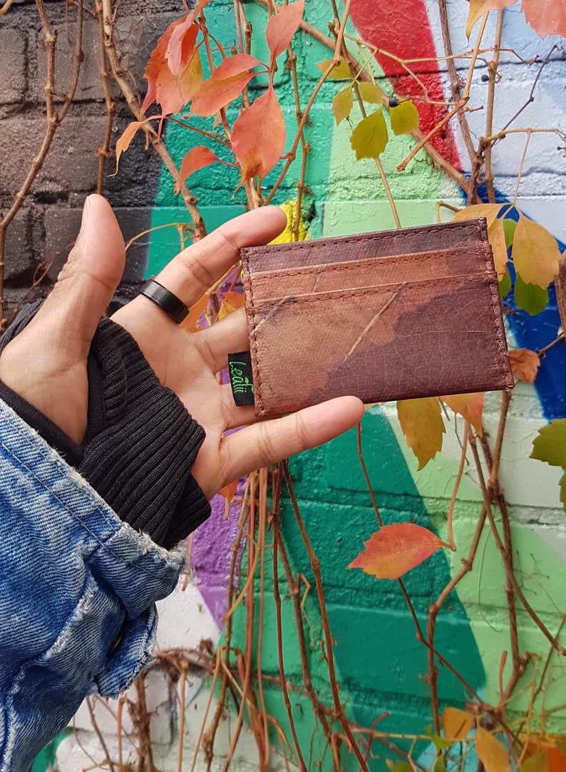 Brown leaf wallet hand holding