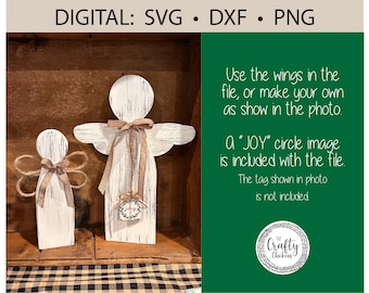 May include: Two white wooden angel figurines with wings. The larger angel has a "JOY" circle image attached to its chest. The smaller angel has a brown ribbon around its neck. The background is a wooden surface with a green and white checkered fabric.