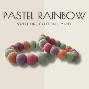 May include: Two pastel rainbow-colored beaded bracelets. The beads are in shades of pink, purple, orange, green, and gray. The text above reads "PASTEL RAINBOW" and below "SWEET LIKE COTTON CANDY."