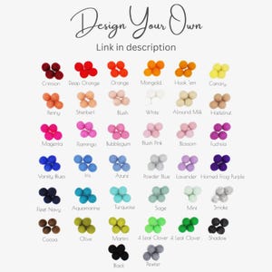 May include: A color chart featuring a variety of felt ball colors, including Crimson, Deep Orange, and Varsity Blues. The text "Design Your Own" is at the top, with "Link in description" below it.