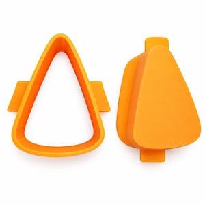 May include: Two orange plastic cookie cutters in a triangular candy corn shape. One piece is an open frame cutter with side tabs, and the other is a solid plunger-style stamp with a matching triangular outline and small top and bottom tabs.