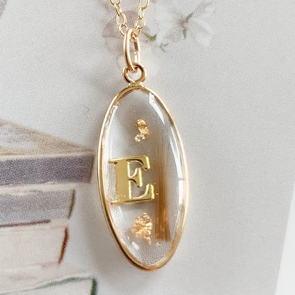 Ovale Kette mit Erinnerungsstücken und Buchstabe