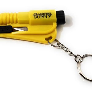 May include: Yellow emergency keychain tool with a black blade and a black end cap. The text "FLASHFIRE SUPPLY" is printed on the side. Includes a silver chain and key ring.