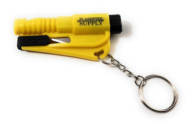 May include: Yellow emergency keychain tool with a black blade and a black end cap. The text "FLASHFIRE SUPPLY" is printed on the side. Includes a silver chain and key ring.