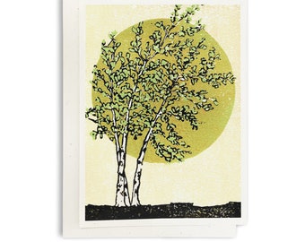 May include: A green and black illustration of two trees with a large yellow circle behind them. The trees have white trunks and green leaves. The background is a light yellow color.