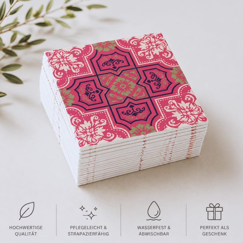 May include: A stack of square coasters featuring a vibrant pink, dark blue, and light green floral tile pattern. The bottom of the image displays four icons with the German text: HOCHWERTIGE QUALIT&Auml;T, PFLEGELEICHT & STRAPAZIERF&Auml;HIG, WASSERFEST & ABWISCHBAR, and PERFEKT ALS GESCHENK.