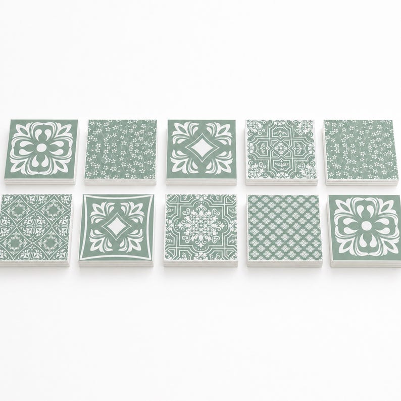 May include: A set of ten square tiles arranged in two rows of five. Each tile features a sage green background with distinct white printed patterns, including floral motifs, geometric shapes, intricate mandalas, and repeating lattice designs.