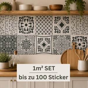 May include: A set of square wall tiles featuring a variety of black and white geometric and floral patterns. The tiles are arranged in a grid on a kitchen backsplash. The text 1m&sup2; SET bis zu 100 Sticker is displayed in the foreground of the image.