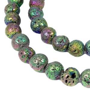 May include: A strand of iridescent lava rock beads. The beads are round and have a rough, textured surface. The beads are a mix of green, blue, purple, and gold.