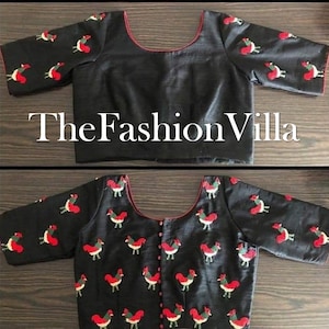 May include: Black blouse with red and white embroidered bird pattern. The blouse has a scoop neckline with red trim and short sleeves. The text "TheFashionVilla" is displayed across the image.